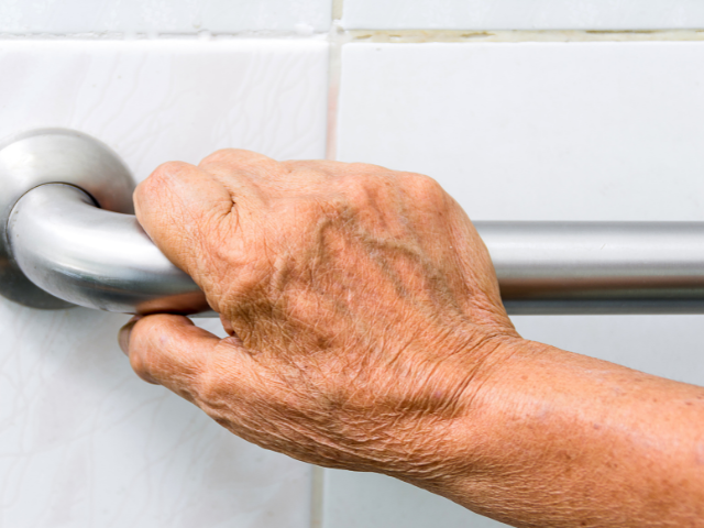 hand-on-grab-bar Aging hand on grab bar